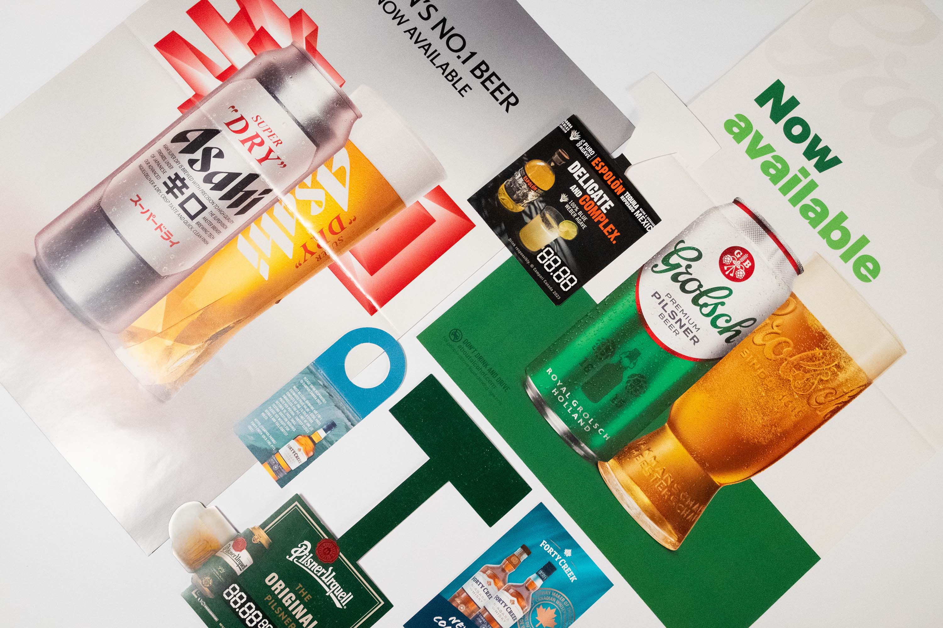 Printed packaging and point-of-sale samples arranged on a light surface.