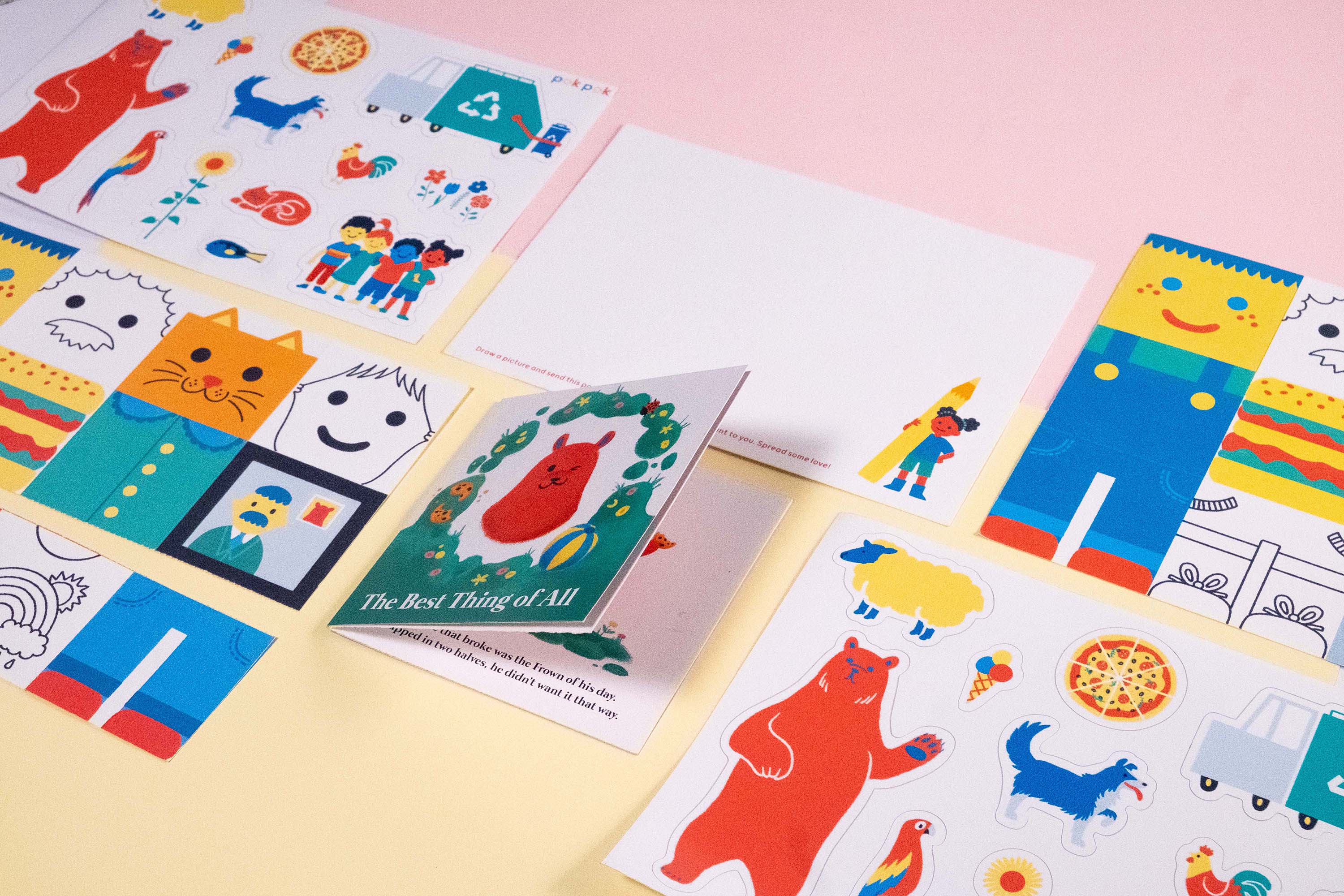 Colorful printed pieces arranged in a wide studio banner.